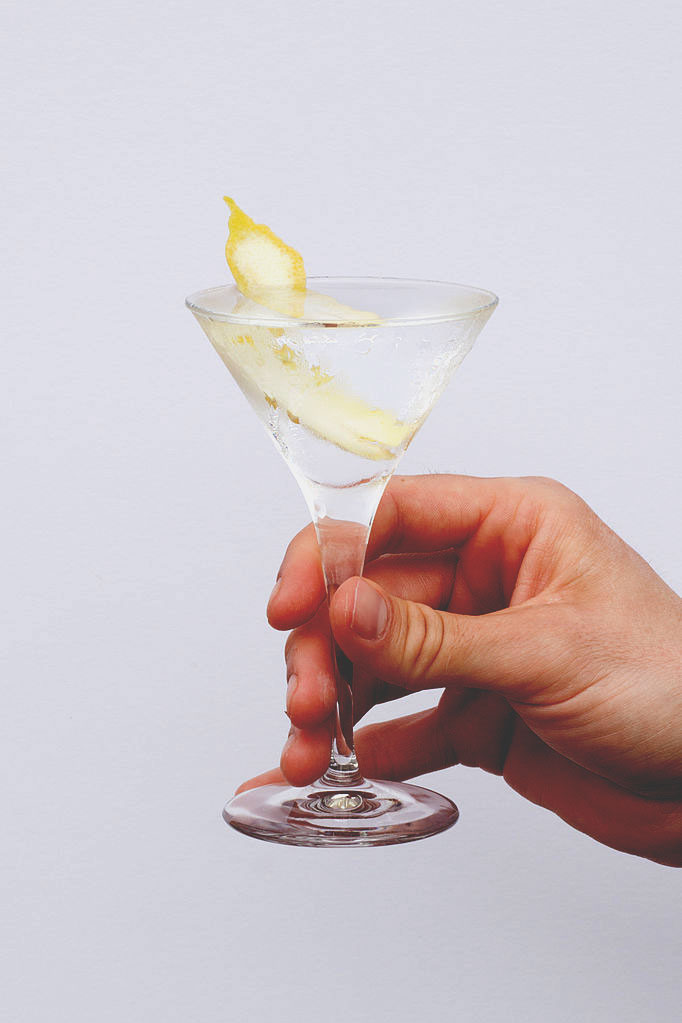 holding a cocktail drink - vodka martini