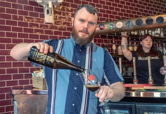 arman pours a bottle of Reforged by AleSmith,